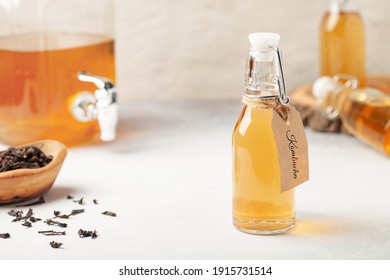 Refreshing filtered kombucha tea in a glass bottle and a jar. Healthy drink