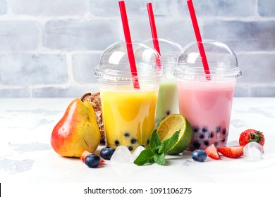Refreshing homemade iced milky bubble tea with tapioca pearls. Fruit and berry bubble tea variety. Raspberry, mango, lemon mint bubble tea on white background