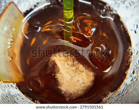 Refreshing iced tea with ice cubes in closeup view.