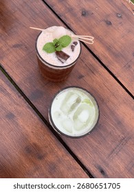 Refreshing iced tea served in a clear glass on a wooden table, with ice cubes glistening under natural light. A delicious homemade beverage perfect for summer