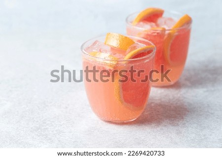 Refreshing low alcohol cocktail with grapefruit on a fresh stone background. Fruity light cocktails,  eco friendly  natural style, soft pastel colors, copy space 
