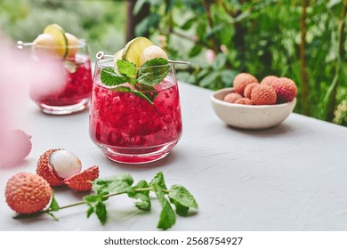 Refreshing lychee drink with raspberry, lime, mint leaves and ice. Non-alcoholic sparkling cocktail fizzy drink perfect for summer hydration.