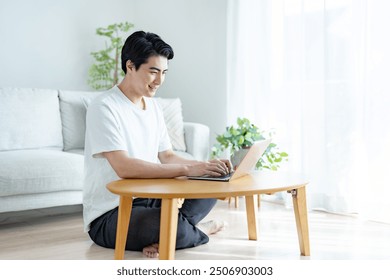 A refreshing man working on a computer at home