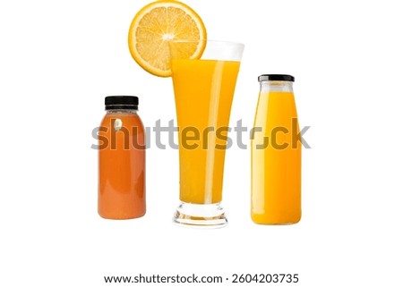 Refreshing orange juice served inside a tall elegant glass with a fresh citrus slice garnish alongside two small plastic and glass bottles filled with vibrant fruit nectar on white background.