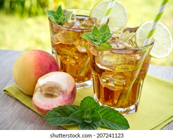 Refreshing peach, lime and mint ice tea served outdoors