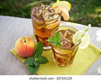 Refreshing peach, lime and mint ice tea served outdoors