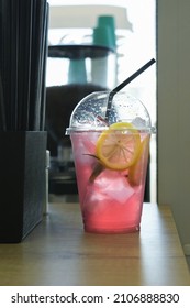 Refreshing Pink Lemon Drink Lemonade In Clear Plastic Glass On Table In Cafe