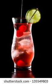 Refreshing Red Cocktail With Sparkling Water And Ice Garnished With A Lime And Cherry