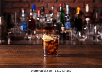 Refreshing Rum And Cola Cocktail On A Bar