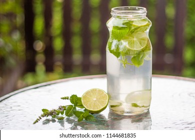 Refreshing Sugar Free Beverage Made Out Of Ice Cold Water, Lime Juice, Slices Of Lime And Fresh Organic Herbs From The Garden, Mint And Lemon Balm. Perfect Healthy Drink On Hot Summer Days.