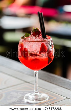 Refreshing summer alcoholic cocktail with ice and fruits