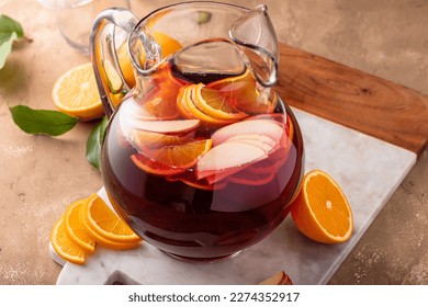 Refreshing summer berry sangria with apples, oranges and blueberry in a pitcher