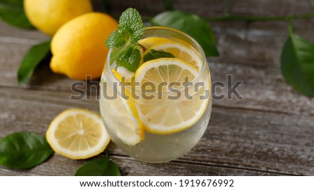 refreshing summer cocktail with lemon slice on the table