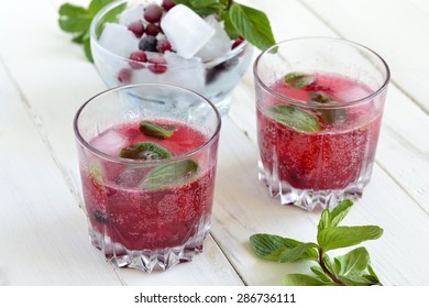 Refreshing summer drink with berries in glasses on a wooden table - Shutterstock ID 286736111