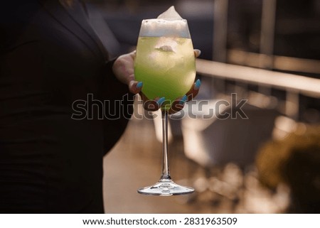 Refreshing summer drink served in a stemware glass during a golden hour party for a luxury lifestyle