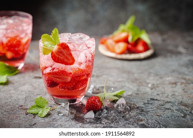 Refreshing summer drink with strawberry slices in glasses on dark background - Powered by Shutterstock