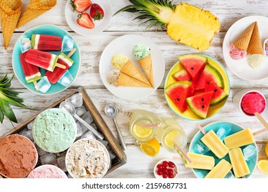 Refreshing summer foods table scene. Variety of ice cream, popsicles and fruit. Top view over a rustic white wood background. - Powered by Shutterstock