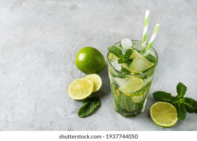 Refreshing Summer Mojito Cocktail With Ice Cubes, Fresh Mint And Lime. A Glass Of Cold Mojito Drink.