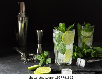 Refreshing Summer Mojito Cocktail With Ice Cubes, Fresh Mint And Lime On Black. Exotic Mojito Beverage.