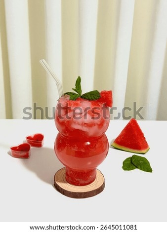 Refreshing Watermelon Drink with Mint and Ice on a Wooden Coaster