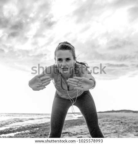 Similar – Young woman stretching arms before training outdoors