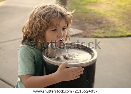 Refreshment solution. Thirsty kid drink water from drinking fountain. Thirst quenching