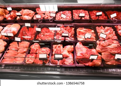 Refrigerated Display Case With Fresh Meat In Supermarket