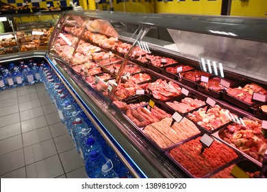 Refrigerated Display Case With Fresh Meat In Supermarket