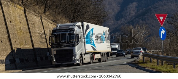 Refrigerated\
truck for transporting vaccine and medicines. Volvo truck with\
container belonging to the company Frigo Express on the mountain\
road. Orsova, Romania, October 23, 2021 \
