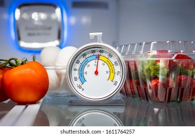 Refrigerator Thermometer With Colorful Food In Cold Storage Unit. Refrigeration Safety Gauge Displaying Safe Food Temperature.