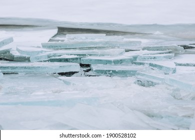 Refrozen Blue Ice Fragments On The River. Ice Surface. Close Up.