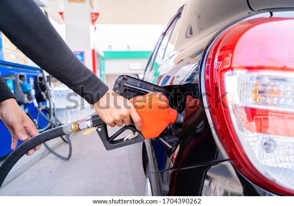 Refuel cars at the fuel pump. The
driver hands, refuel and pump the car's gasoline with fuel at the
petrol station. Car refueling at a gas station Gas
station