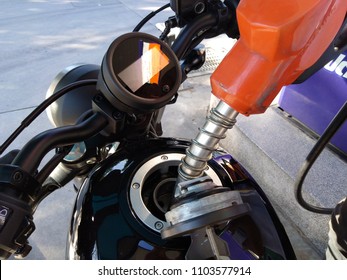 Refuel Tank Of Gas For A Black Motorcycle At The Petrol Station.