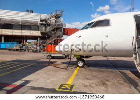 Refueling the aircraft. Tanking small airplane outdoors. Transportation concept.