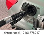 refueling Car fill with petrol gasoline at gas station and petrol pump filling fuel nozzle in fuel tank of car