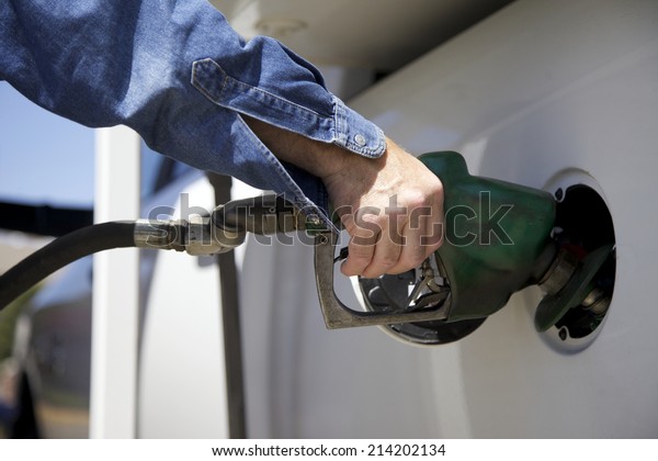 Refueling a car at the\
filling station