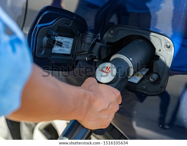 Refueling the car with hydrogen at a hydrogen\
fuel station