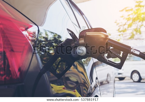 Refueling car tank
with gasoline nozzle
head
