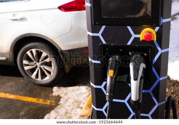 refueling an electric car. Electro\
charging. Recharging for electric cars. Energy,\
ecology