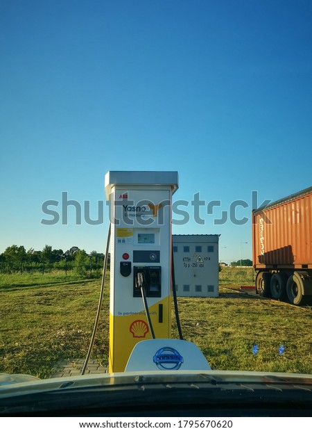 Refueling electric car\
Nissan Leaf on Shell Gas station. View through windshield. Network\
of charging stations Yasno on Kiev-Odessa Track. August 2020, Kiev\
Ukraine.
