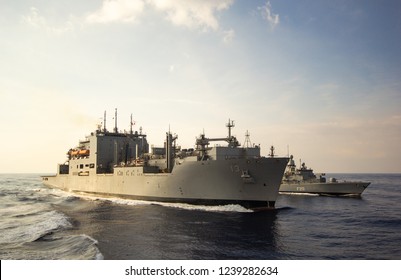 A Refueling Exercise At Sea With Military Ships