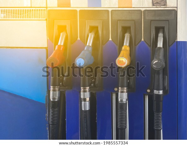 Refueling gasoline. Gas station with nozzles for\
filling the car with fuel. Gas station pump. Multi-colored gas\
pumps. Gas station