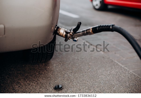 refueling gray\
car gas gun connection in\
bumper\
\
