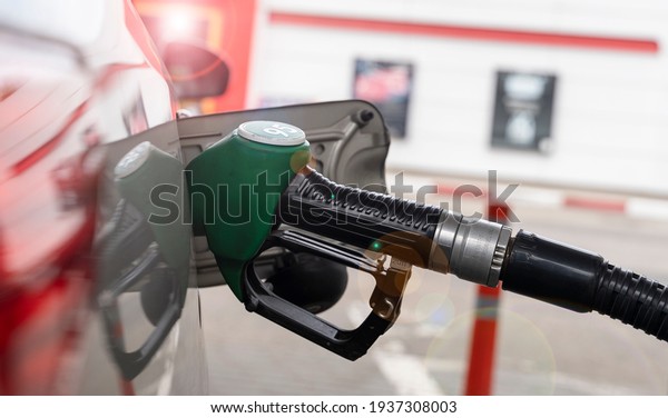 refueling gun in the gas tank, the concept of\
increasing fuel\
prices