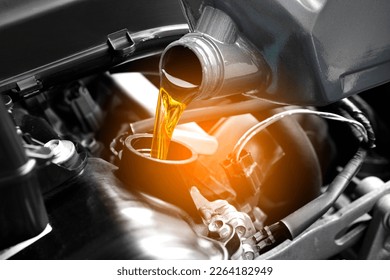 Refueling and pouring oil quality into the engine motor car Transmission and Maintenance Gear .Energy fuel concept. - Shutterstock ID 2264182949