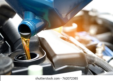 Refueling and pouring oil quality into the engine motor car Transmission and Maintenance Gear.Energy fuel concept. - Shutterstock ID 762072385