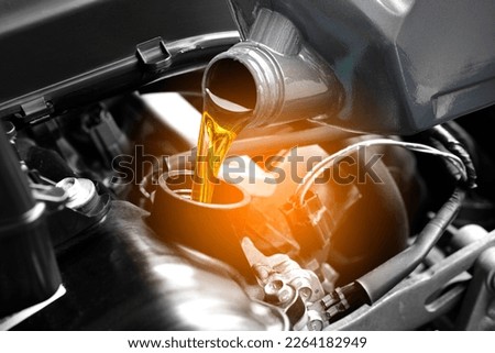 Refueling and pouring oil quality into the engine motor car Transmission and Maintenance Gear .Energy fuel concept. Foto stock © 