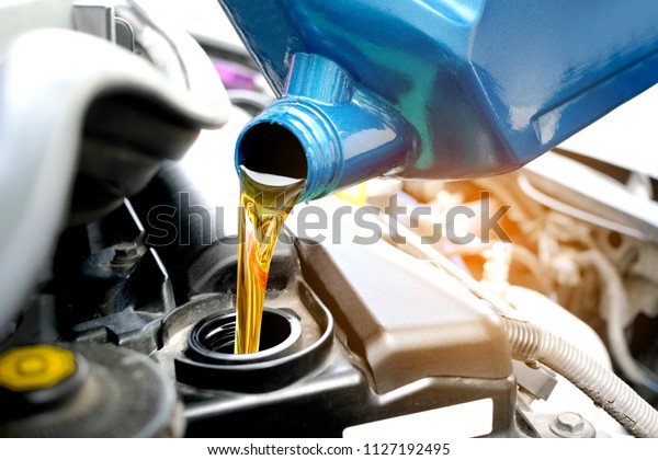 Refueling and\
pouring oil quality into the engine motor car Transmission and\
Maintenance Gear .Energy fuel\
concept.