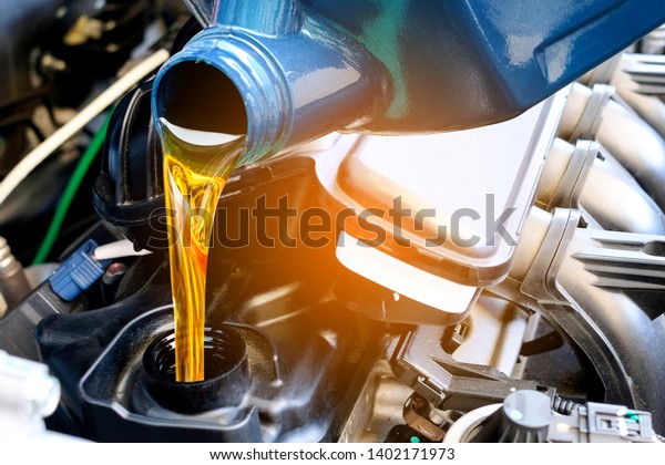 Refueling and\
pouring oil quality into the engine motor car Transmission and\
Maintenance Gear .Energy fuel\
concept.