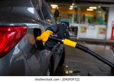 Refueling Refilling Car Vehicle With Fuel At Refuel Fuel Gas Pump Station - Petrol Diesel Gas Pump Gun In The Tank To Fill